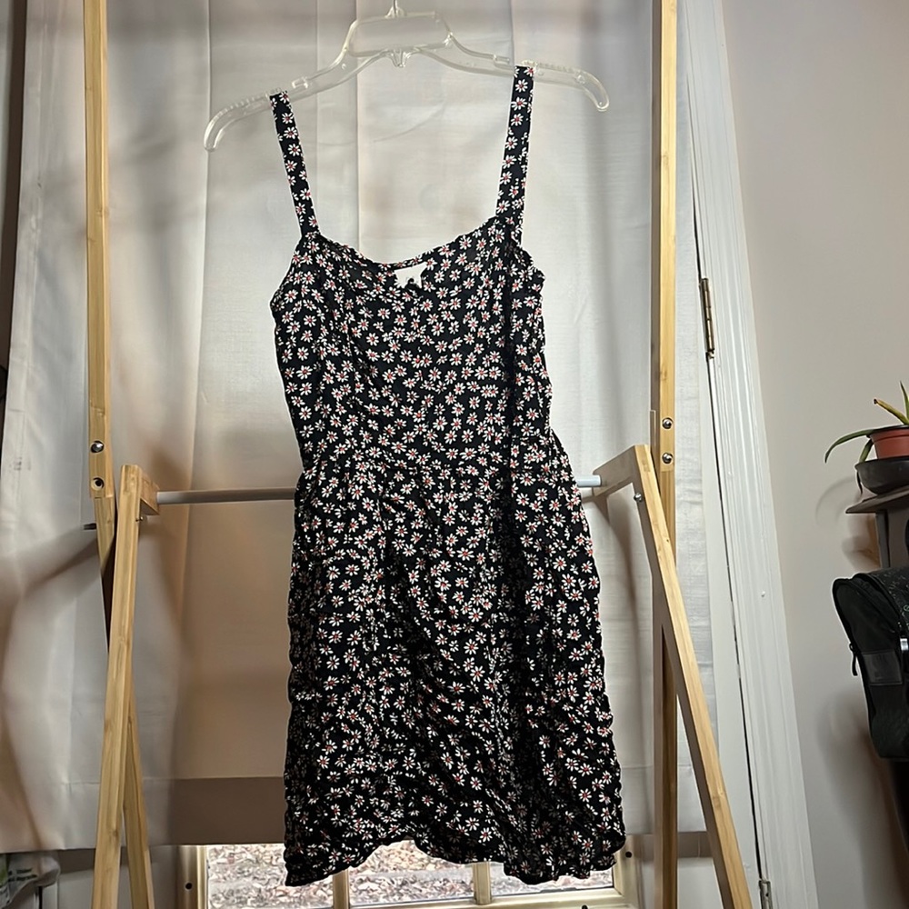 Black sundress with daisies on it.